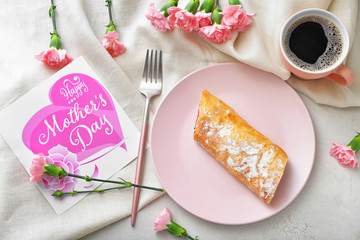 Card with text "Happy Mother's day" and tasty breakfast on table