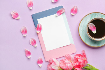 Composition with empty greeting card and cup of coffee on color background