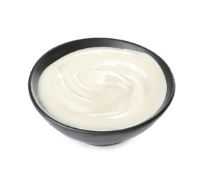 Bowl with tasty cream cheese on white background