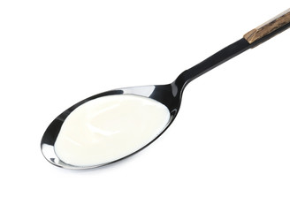 Spoon with tasty cream cheese on white background
