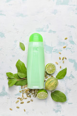 Composition with shampoo and natural ingredients on light background