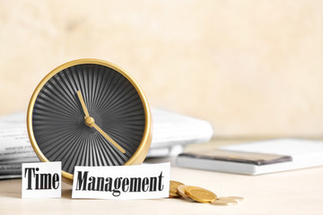 Alarm clock and money on table. Time management concept