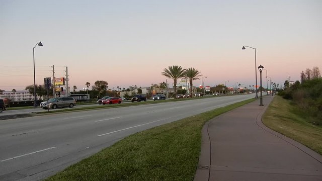 Fpv First Person View Walking Down Sidewalk Sunny Florida Palm Trees Orlando Near Sunset With Traffic On Road