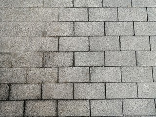 grey granite tiles are laid on the streets of the city