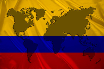 silhouette of a world map on the silk national flag of the modern Colombia state with beautiful folds, concept of tourism, travel, emigration, global business