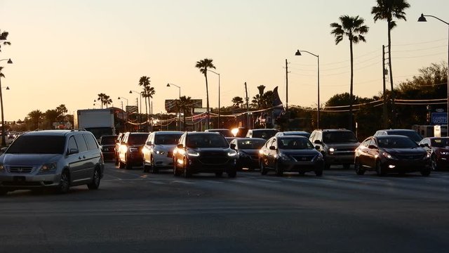Traffic On Sunny Strip Highway Freeway Florida Tourist Palm Trees Vacation Location At Sunset