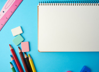 open notebook in the middle with blank white sheets, top view, concept of back to school