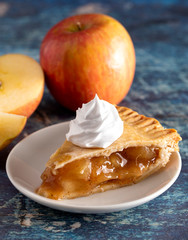 Slice of Homemade Apple Pie on a Rustic Wooden Table