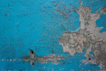 Old blue paint peeling on concrete wall, abstract background, Selective focus 