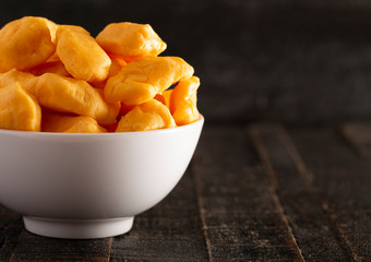Bowl of Cheddar Cheese Curds on a Rustic Wooden Table