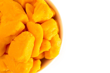Fototapeta na wymiar Bowl of Cheddar Cheese Curds Isolated on a White Background