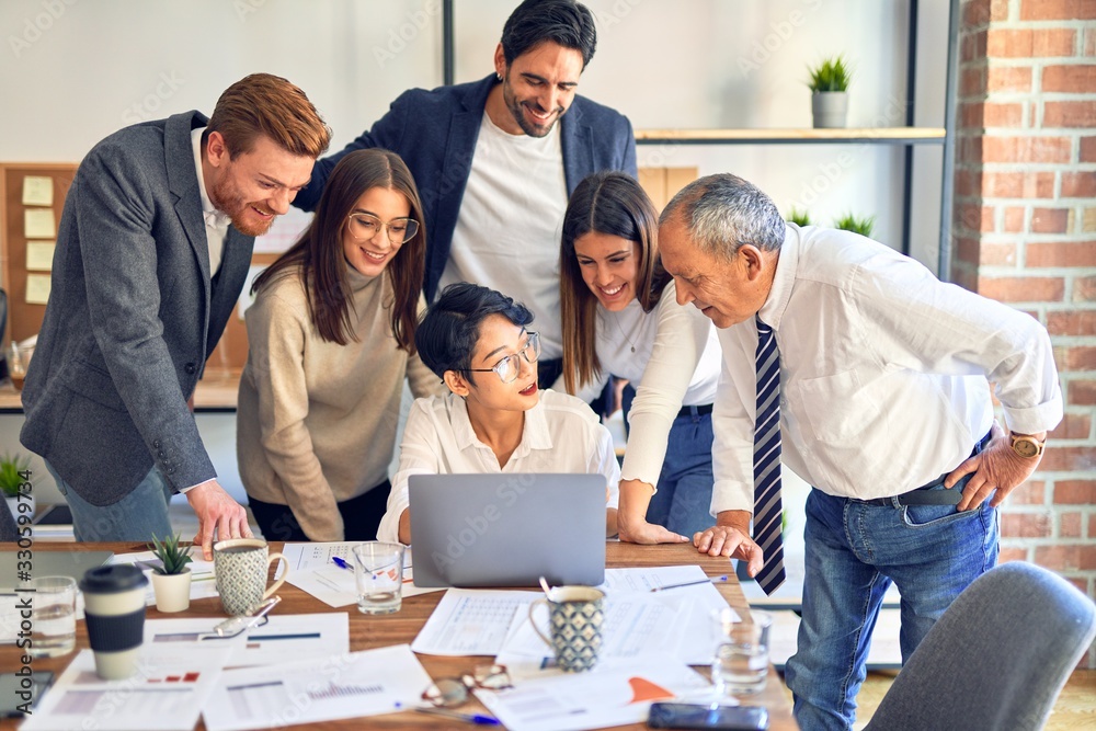 Wall mural group of business workers smiling happy and confident. one of them sitting and partners standing aro