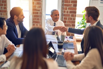 Group of business workers smiling happy and confident. Working together with smile on face shaking hands at the office