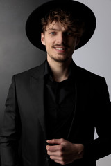 Charming fashion model smiling while wearing hat