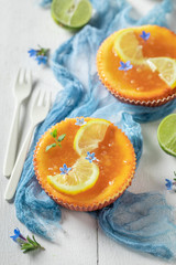 Sweet and golden lemon cheesecake on white table