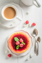 Sweet and fresh raspberry cheesecake with red jelly