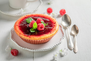 Hot and sweet raspberry cheesecake with red jelly