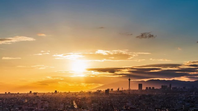 4K Tehran skyline day to night timelaps with beautiful sunset, blue sky and lovely clouds.
