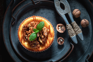 Fresh and sweet walnut cheesecake on dark plate