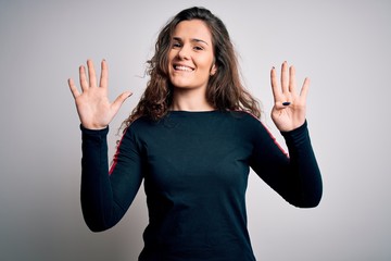 Young beautiful woman with curly hair wearing casual sweater over isolated white background showing...