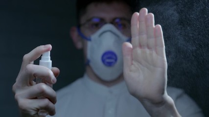 Scientist using hand sanitizer alcohol spray rub for hands hygiene in hospital for preventive coronavirus spread epidemic prevention.