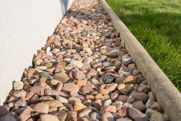 pebble stone around a face building