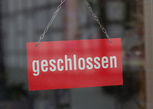sign with the german word for closed (geschlossen) on a shop