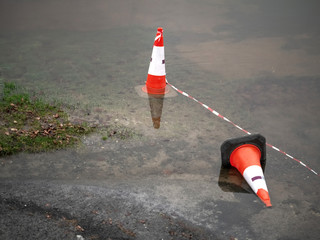 Traffic cone in water during flood.