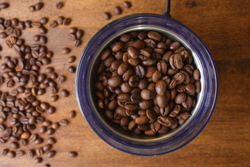 Fototapeta premium coffee beans in an electric coffee grinder