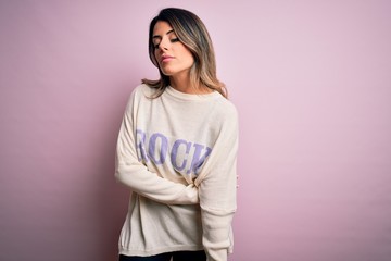 Fototapeta premium Young beautiful woman wearing fashion urban clothes, model wearing casual street style standing over pink background