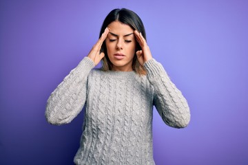 Young beautiful woman wearing casual sweater standing over isolated purple background with hand on head for pain in head because stress. Suffering migraine.