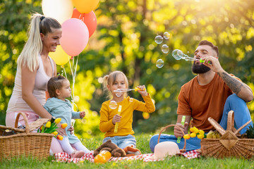 Happy family in the park together on a sunny day