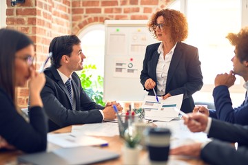 Group of business workers working together in a meeting. Listening one of them speaking at the office.