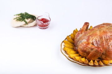 homemade baked chicken served with slices of baked potato on white background. 