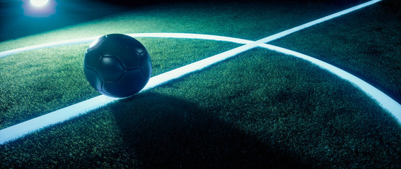 Sports field with football illuminated at night