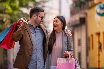Happy smiling couple with shopping bags