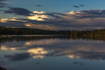 The sun setting over the lake with some interesting clouds in the sky. Sweden