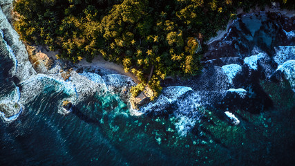 Aerial drone photo of an observation deck placed on a tropic seashore coast surrounded by turquoise transparent ocean, view from the top