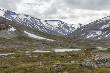 Norwegian summer landscape, wonderful view of snow-capped mountains with clean, cold air in summer, selective focus.