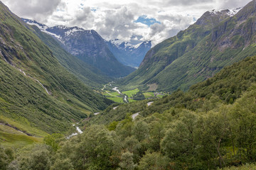 Naklejka premium Norway, Beautiful View Of Mountain with cloudy sky and Green Valley, Norway Mountain Landscape selective focus