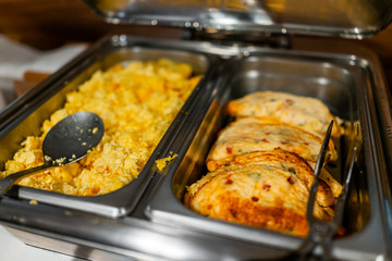 Fresh hot buffet tray with spoon to serve food scrambled eggs omelette in banquet, wedding, or restaurant inside for morning continental breakfast in hotel motel