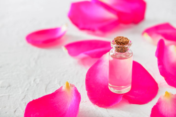 Obraz na płótnie Canvas Bottle of rose essential oil on white background