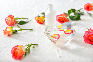 Fototapeta na wymiar Rose essential oil on white background