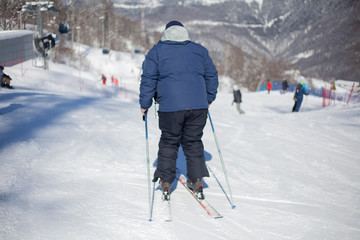 Fototapeta na wymiar A skier on a slope rides.
