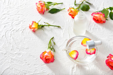 Rose essential oil on white background