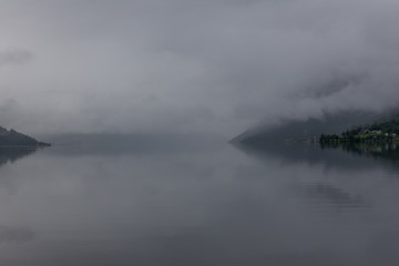 End of fjord. Beautiful Norwegian landscape. view of the fjords. Norway ideal fjord reflection in clear water In cloudy weather. selective focus
