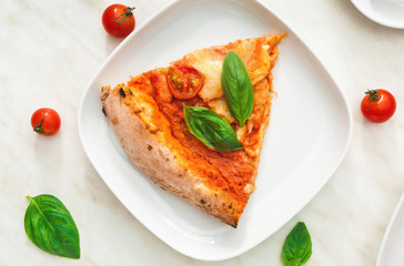 Plate with slice of delicious pizza Margherita on table