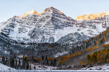 Maroon Bells morning sunrise sunlight on peaks view in Aspen, Colorado rocky mountain and autumn...