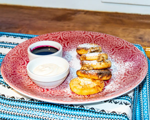 Traditional Ukrainian cheesecakes with sour cream and jam