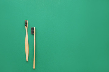 Wooden tooth brushes on color background